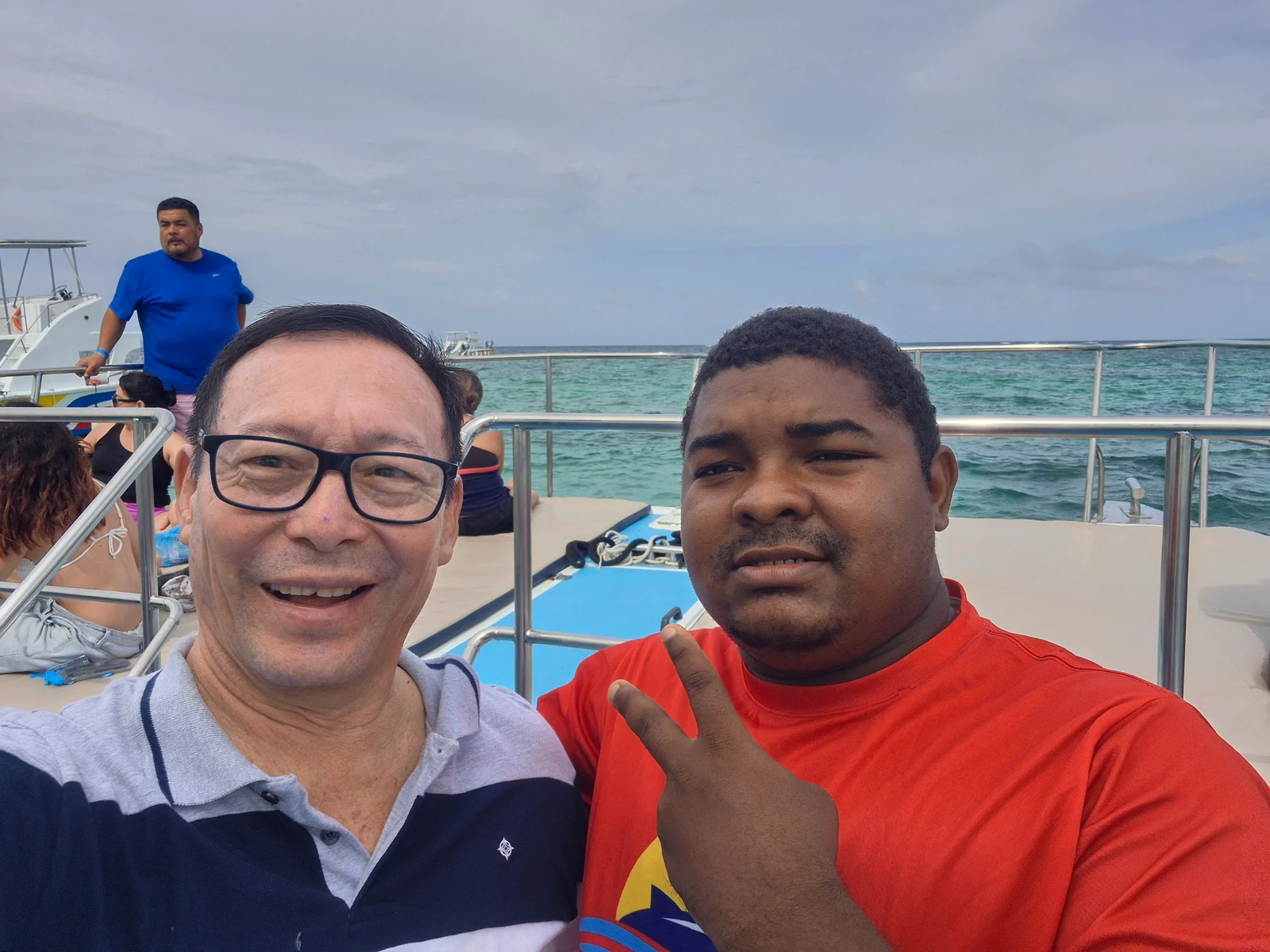 Pedro and another guest on board with the sea behind them